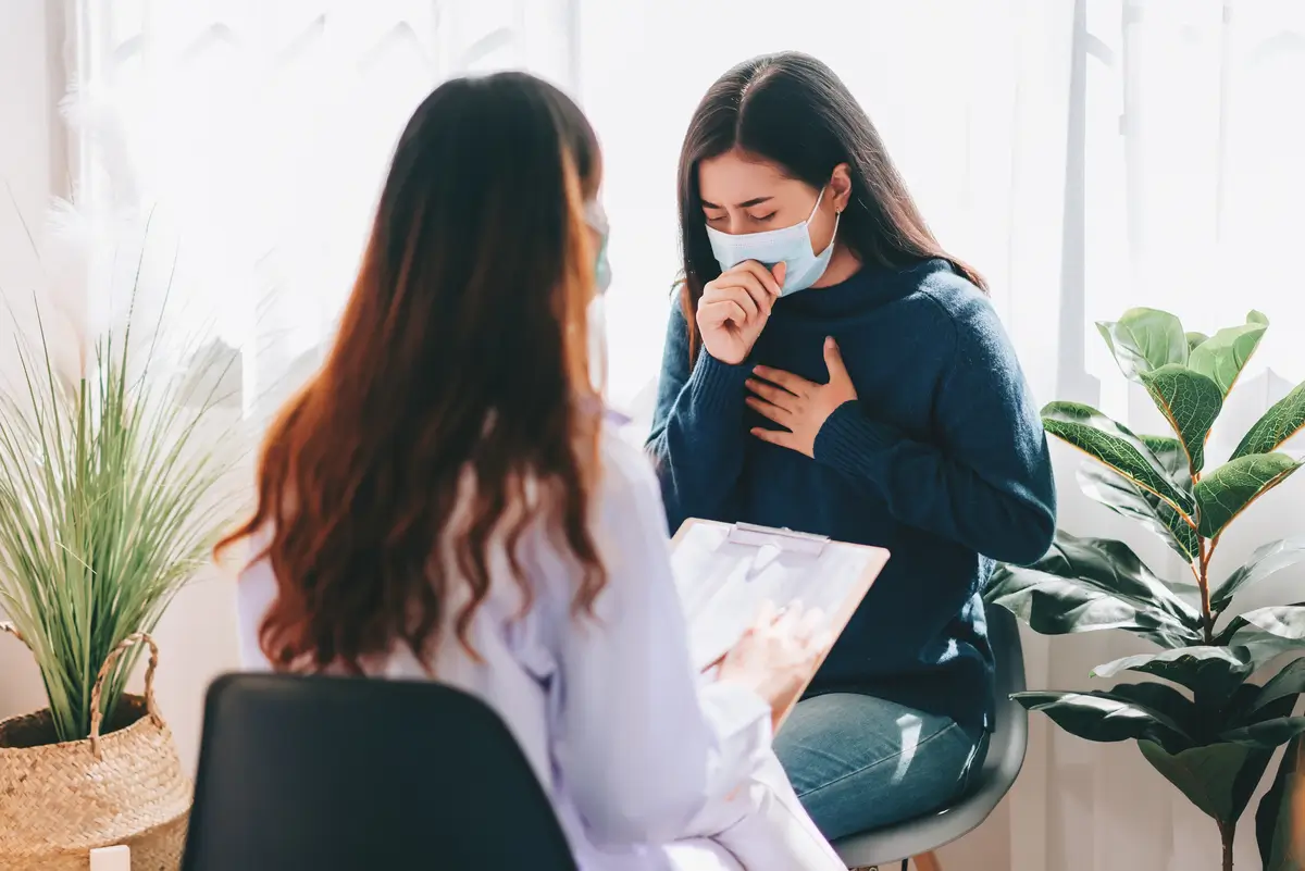 asian-doctor-visit-examines-young-adult-woman-hospital-with-cough-flu-symptomthe-doctor-checking-up-consulting-health-care